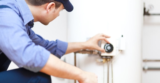 man looking at water heater